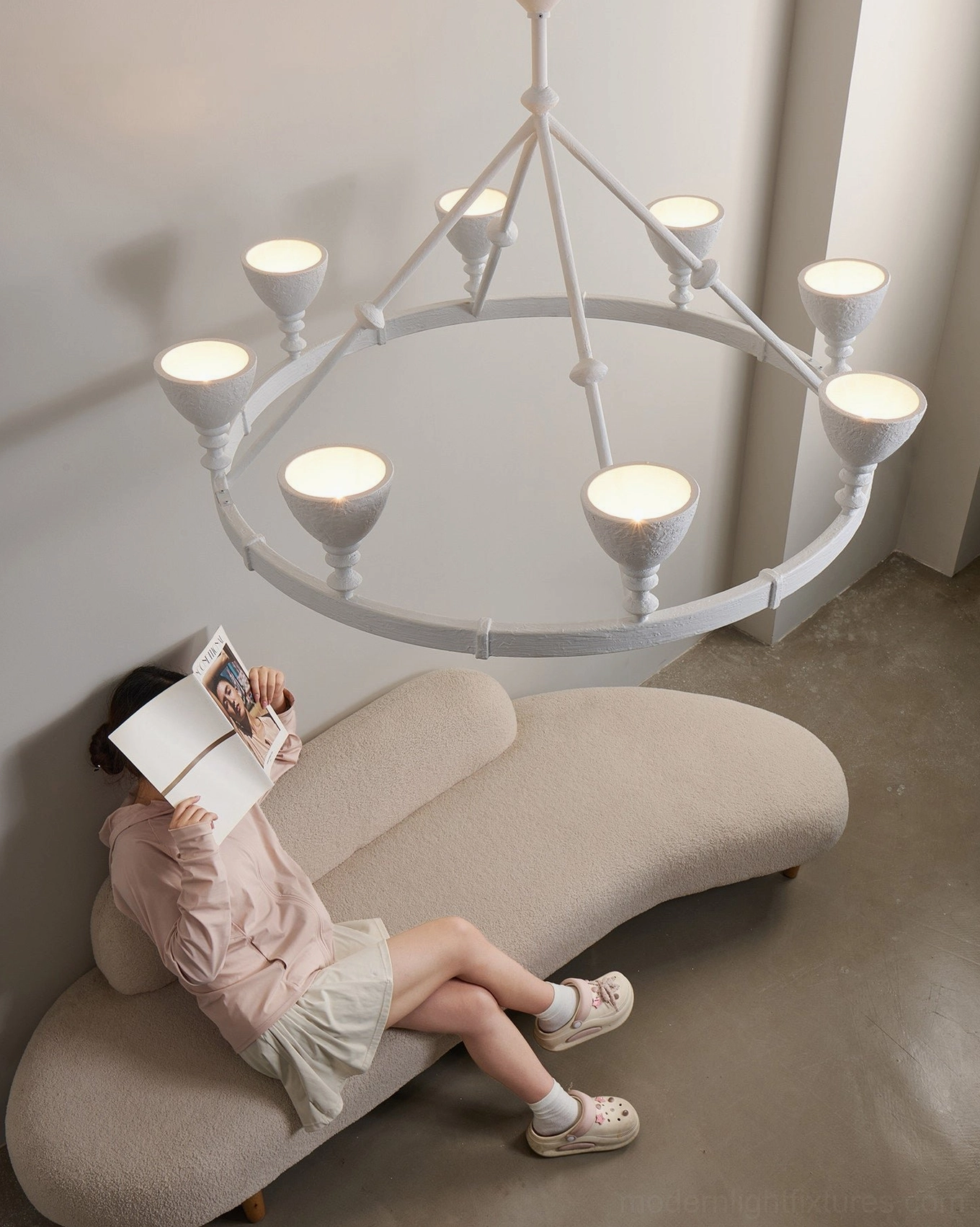 Cremora white ring chandelier demonstrating monochromatic minimalist design with goblet candle cup details