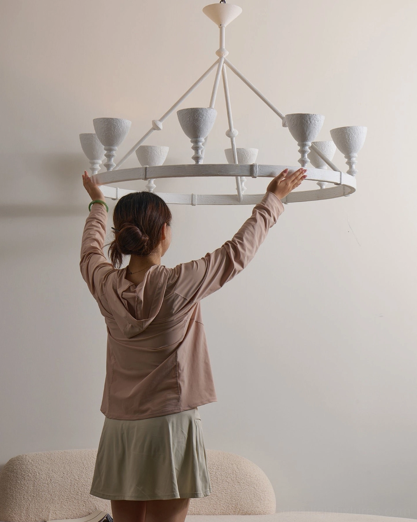 Cremora ring fixture low-angle view in living room with beige sofa demonstrating neutral home decor integration