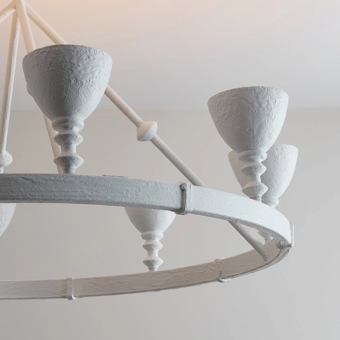 Cremora sculptural ring fixture detail showing textured white plaster and brass hardware construction