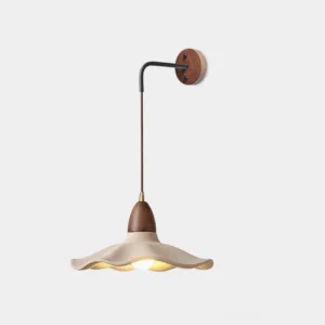 Crested wave wall sconce with matte cement shade and wood accents, front studio view showing sculptural undulating design