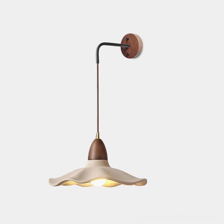 Crested wave wall sconce with matte cement shade and wood accents, front studio view showing sculptural undulating design