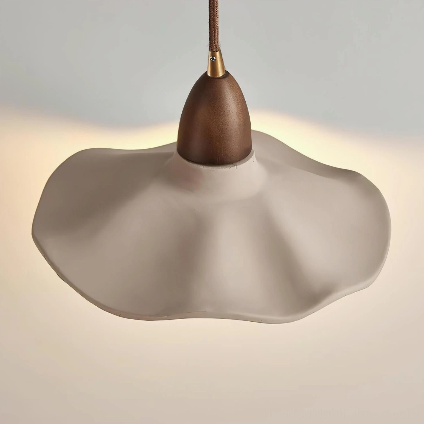 Crested wave wall sconce detail view showing cement material texture and wood accents with modern design elements
