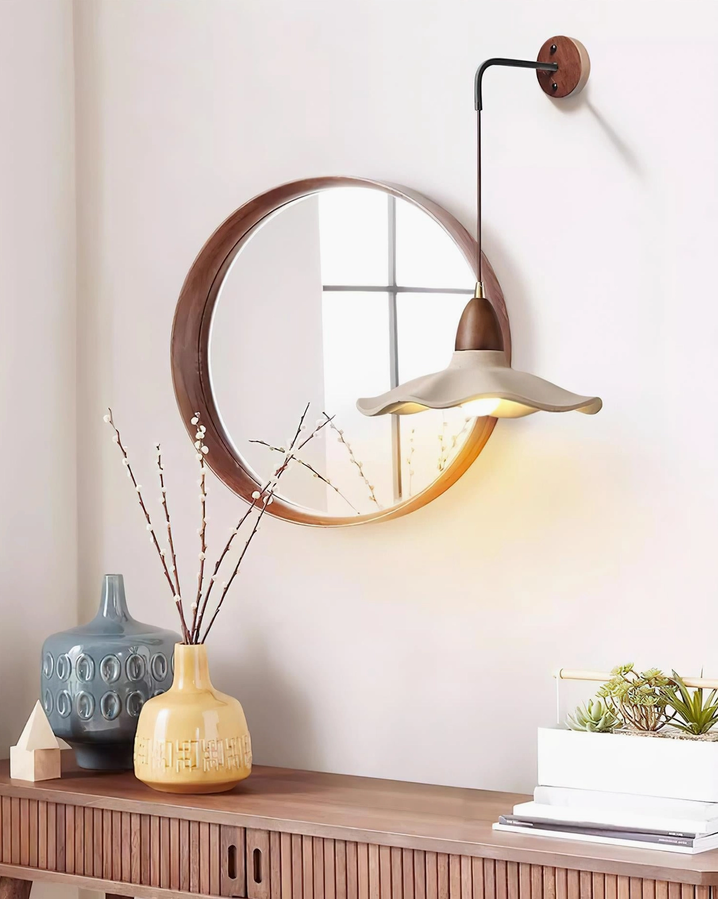 Japandi wall sconce installed in contemporary entryway, displaying warm ambient lighting over wooden console table