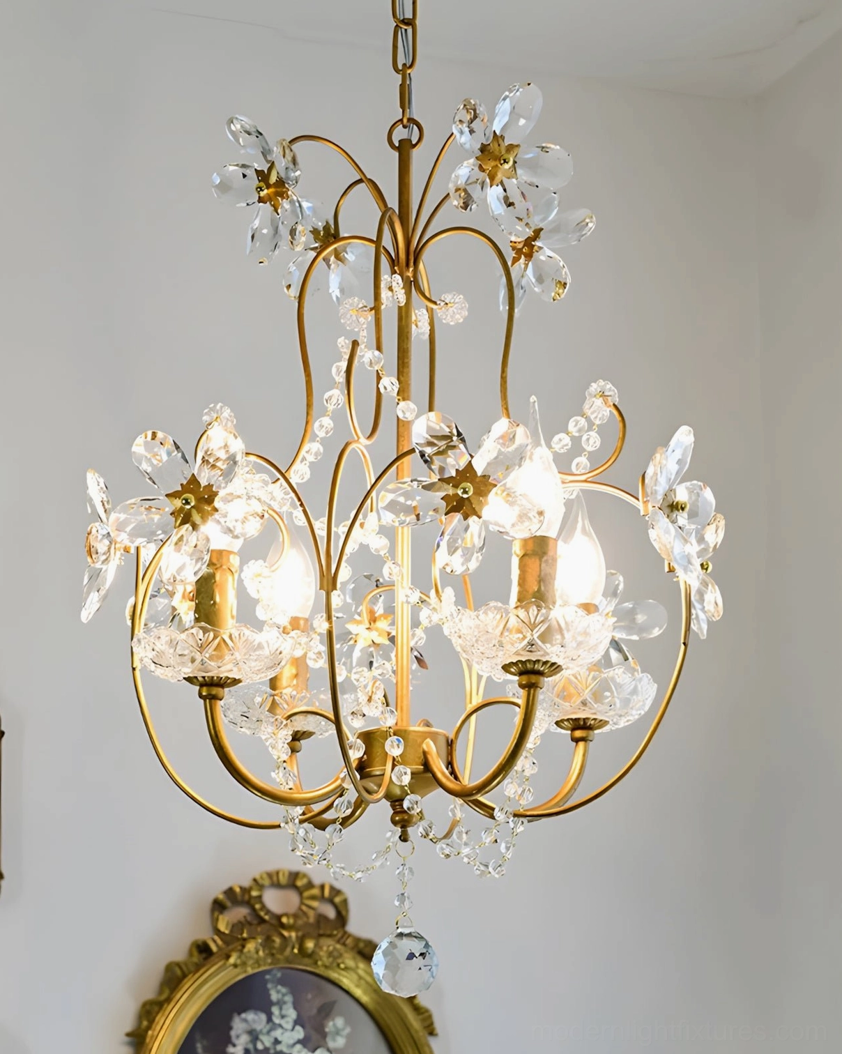 Brass and crystal chandelier fixture displaying ornate beaded accents and cascading crystal elements