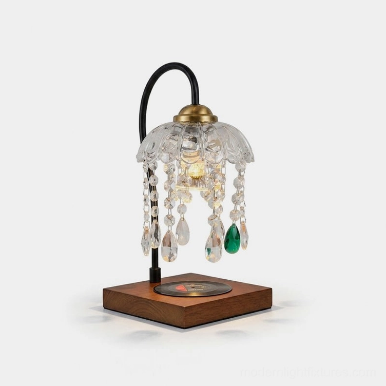 Crystal candle warmer lamp with black metal arm, hanging glass bead and teardrop crystal dangles, clear scalloped dome, and square wood base with record-style plate on white background