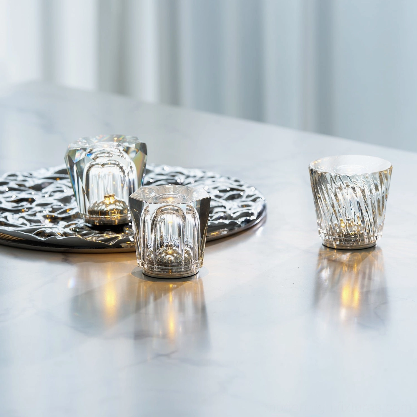 Crystal diamond table lamp displaying prismatic light refraction through faceted clear crystal glass, warm ambient glow
