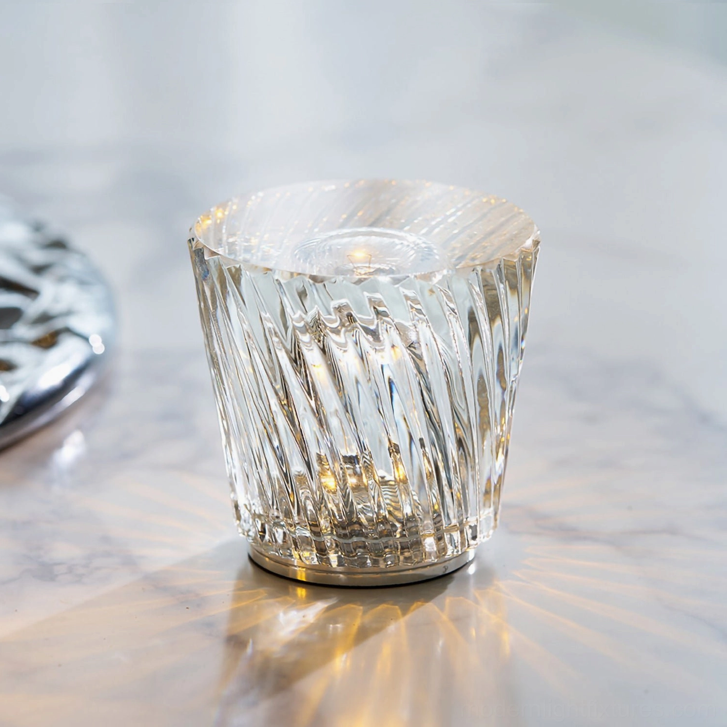Cordless crystal diamond table lamp with twisted fluted clear crystal design, polished metal base, eye-level front view on marble surface
