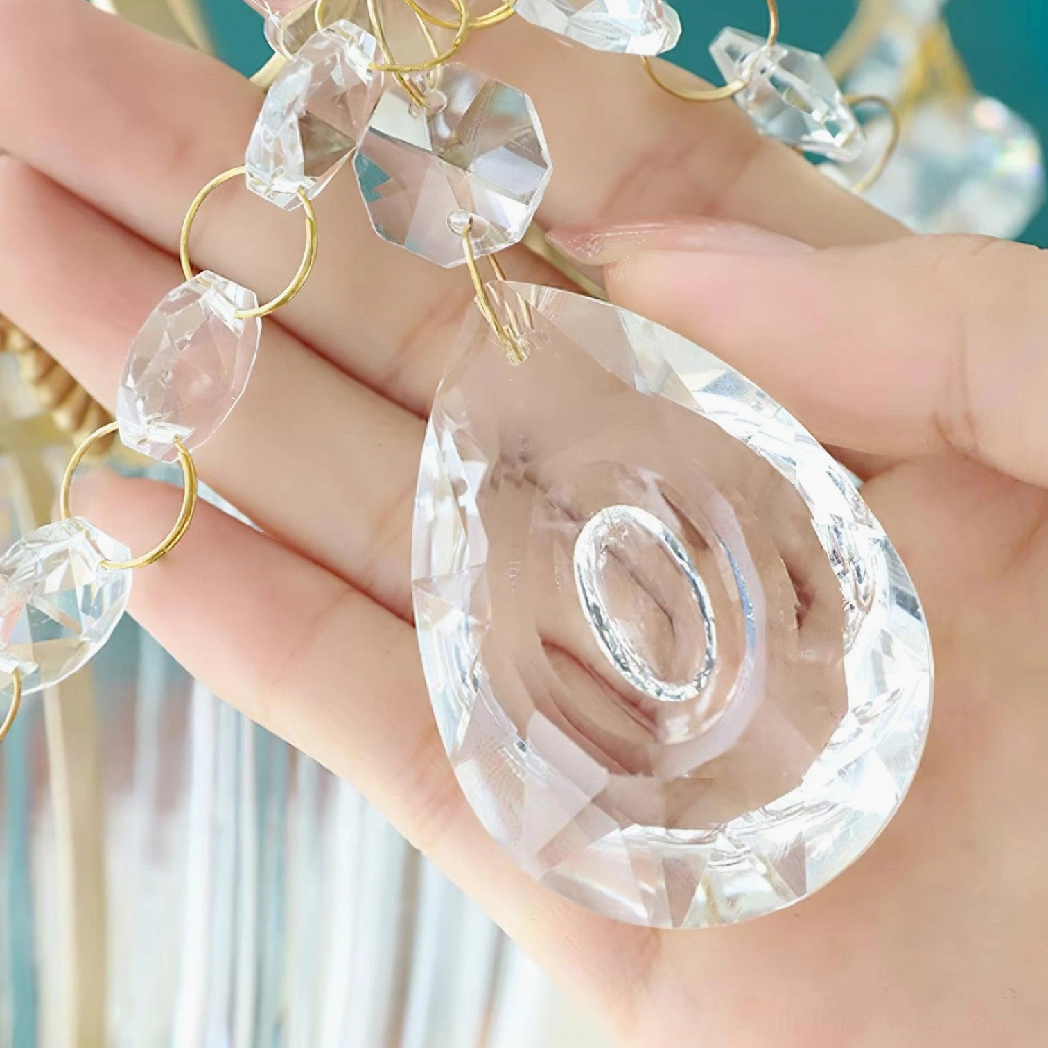 Close-up of faceted crystal and brass chain hanging hardware on vintage pendant light