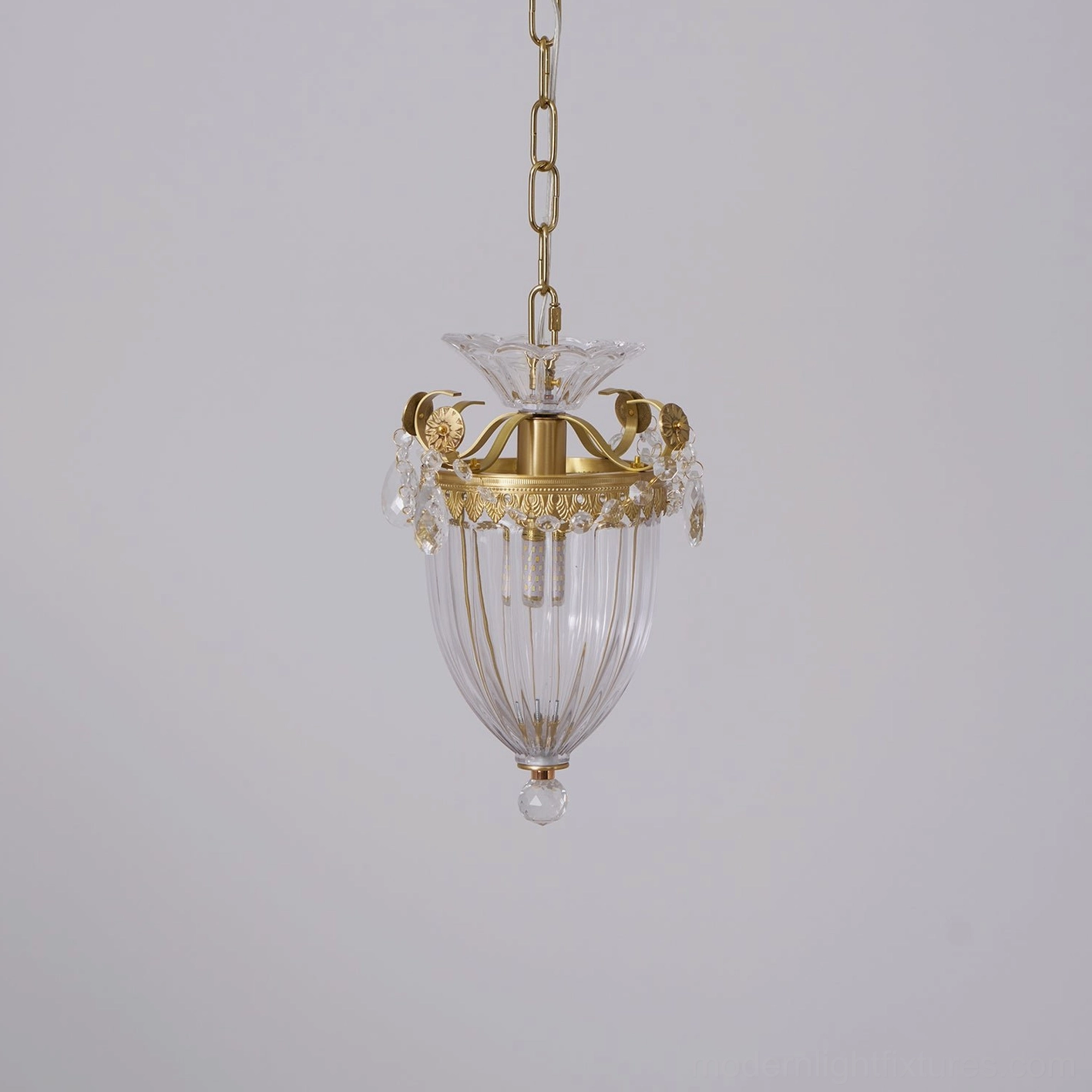 Rear view of brass crystal pendant light showing ornate hardware and glass shade construction