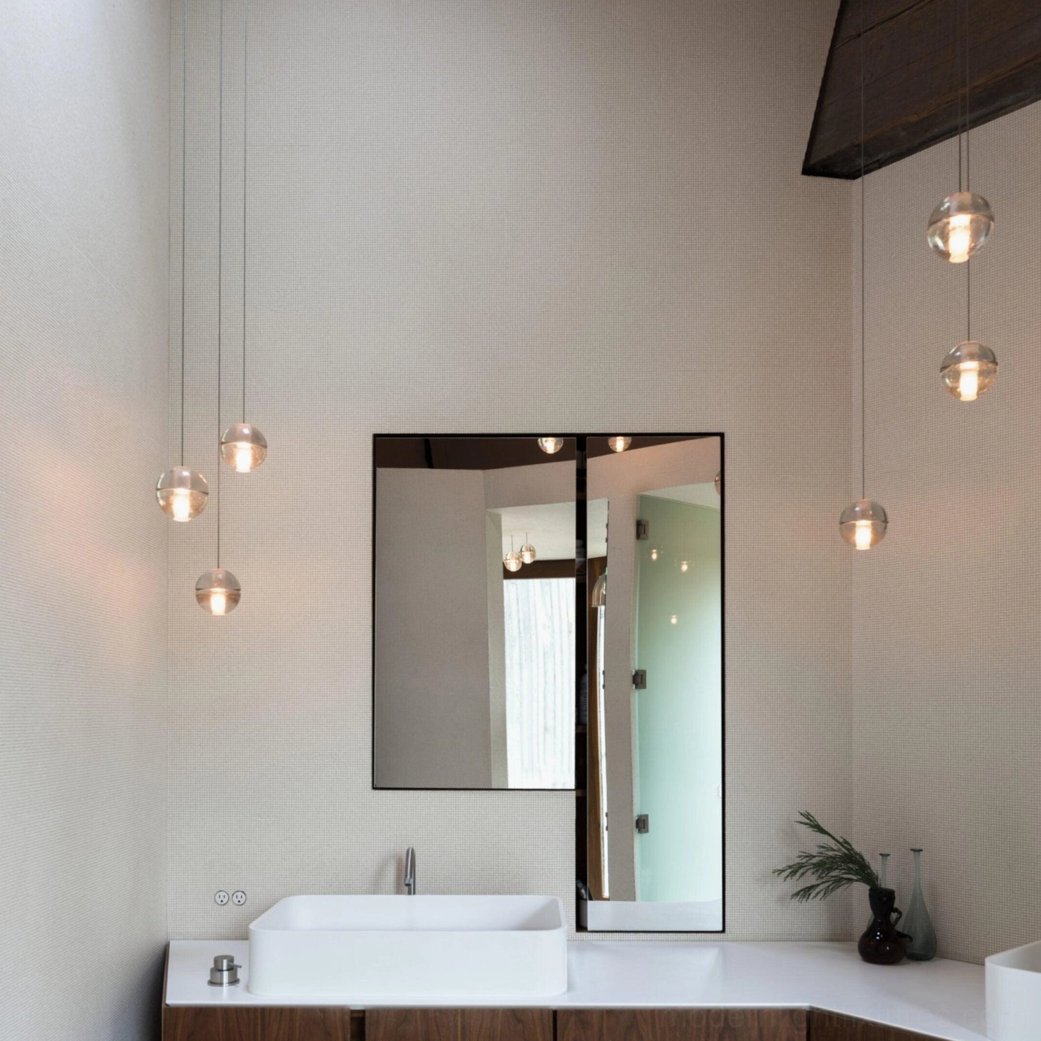 Contemporary glass pendant light above bathroom vanity with minimalist aesthetic