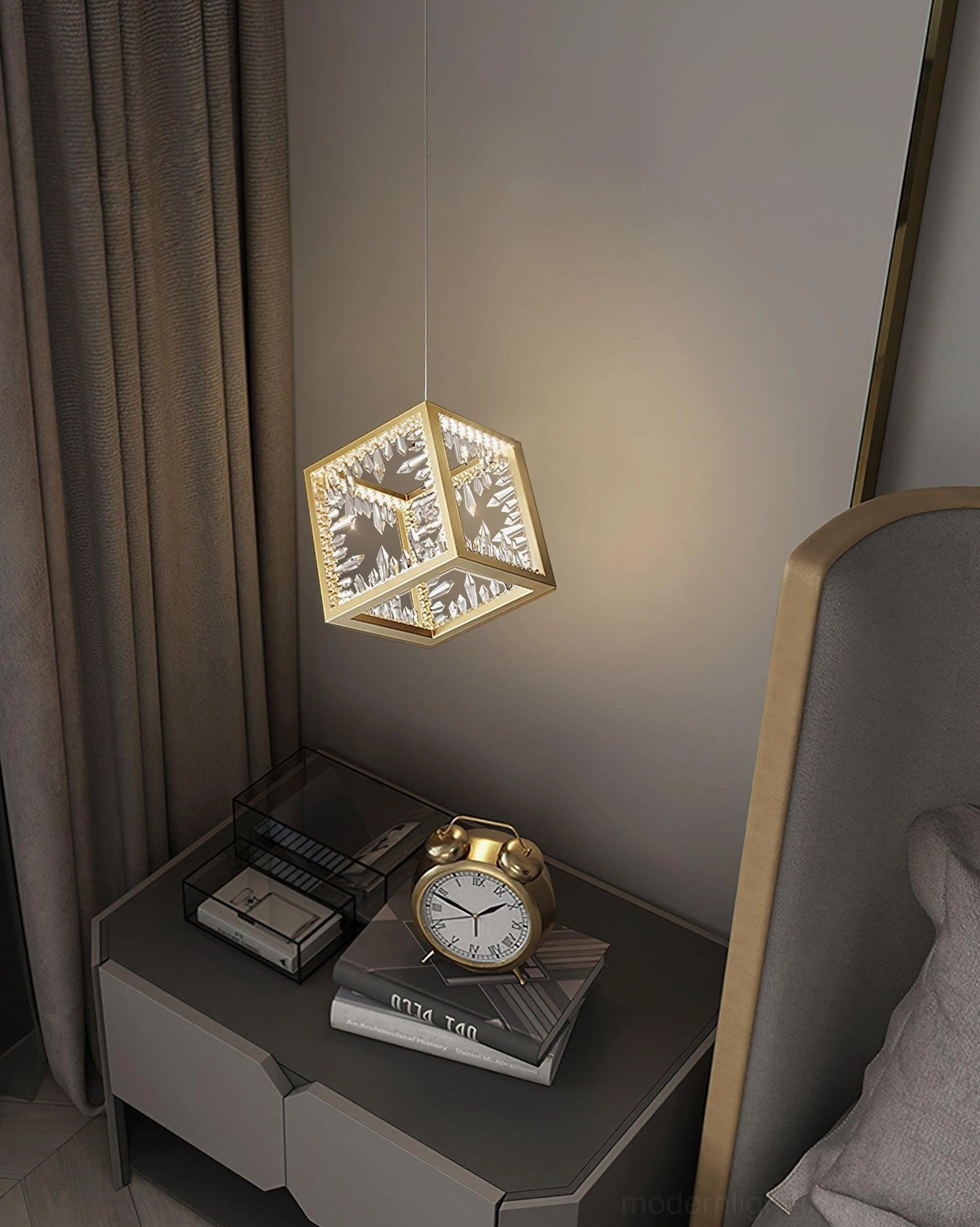 Side view of gold metal frame cube pendant light mounted above bedroom nightstand