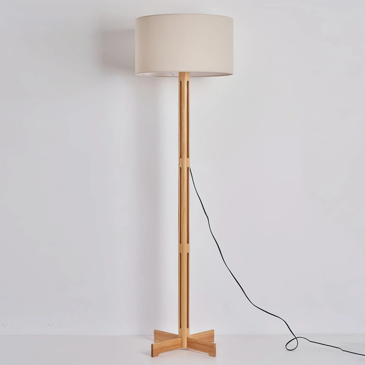 Culver minimalist wood floor lamp showing exposed power cord and perforated wooden pole on neutral background
