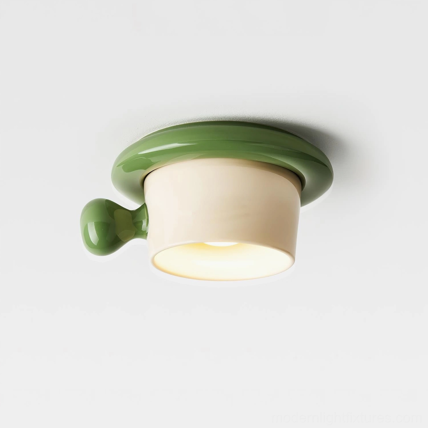 Green glossy ceramic teacup ceiling light close-up front view studio photography