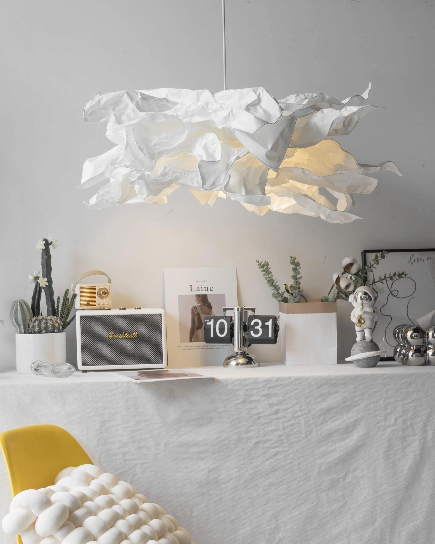 Artisanal paper pendant light installation showing customizable folding and shaping possibilities