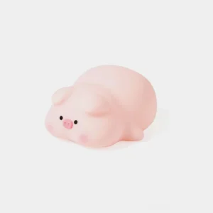 Adorable pink silicone pig night light with cute facial features, front view on white background
