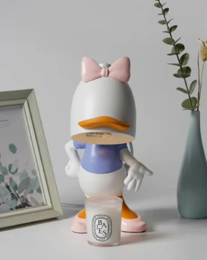 Daisy Duck candle warmer lamp in pink and white color scheme displayed on home desktop with decorative bow detail, ambient home décor scene