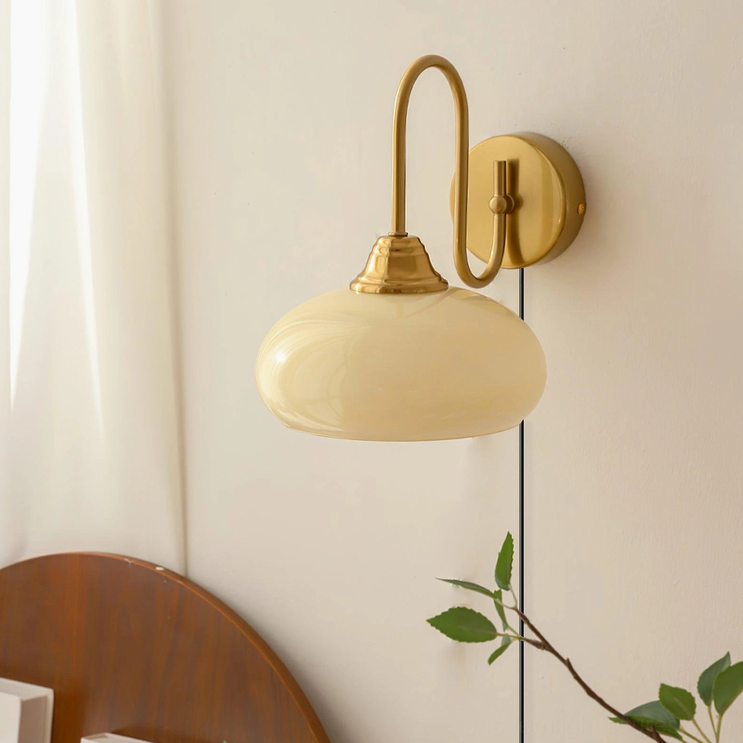 Damp-rated plug-in wall light in chrome finish with textured glass dome, installed on covered porch with warm ambient glow