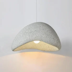 Close-up detail of Danalite resin pendant lamp showing textured speckled surface and downlight opening with warm beige interior finish