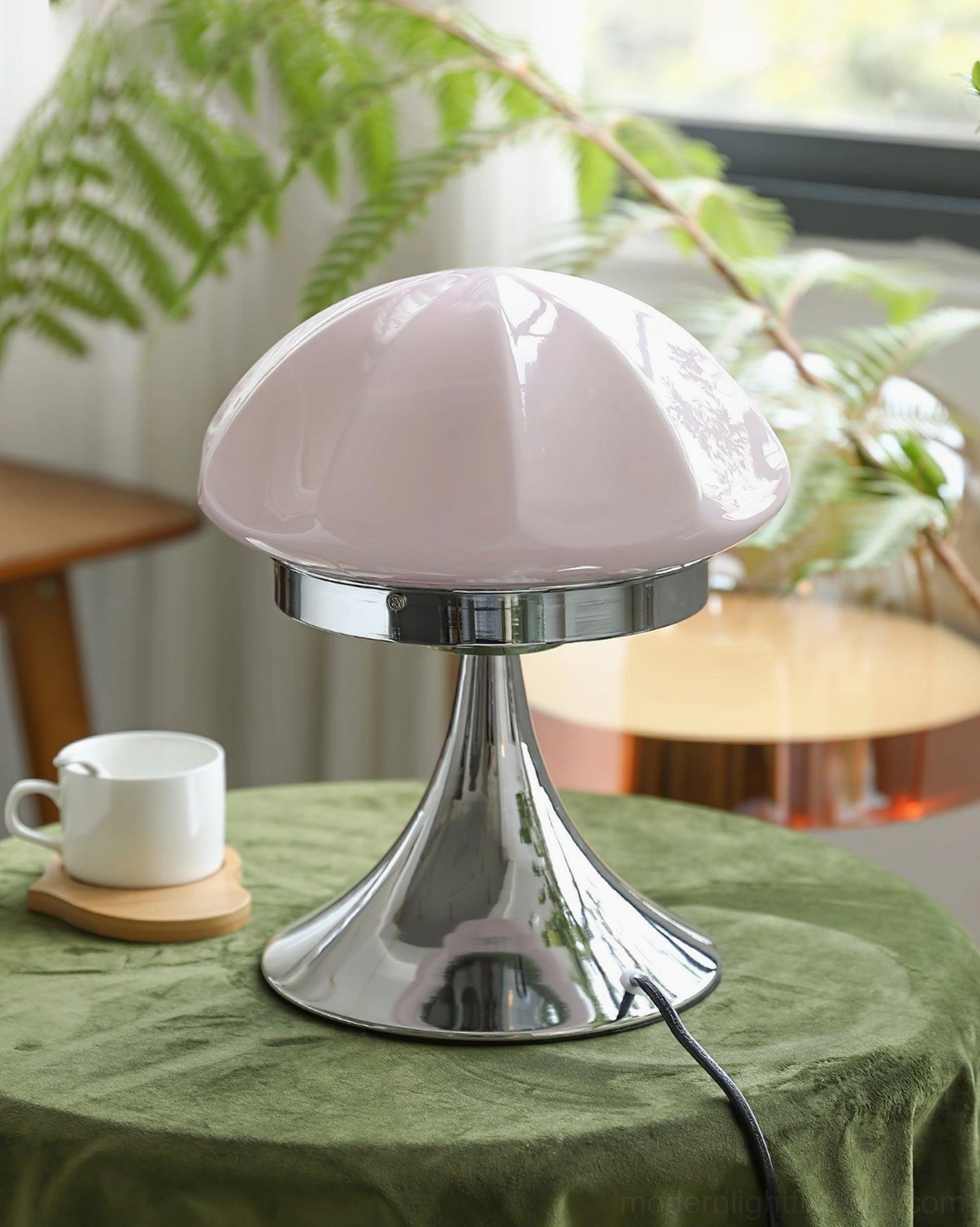 Dario mushroom table lamp with pale pink faceted glass shade on green velvet side table with decorative elements