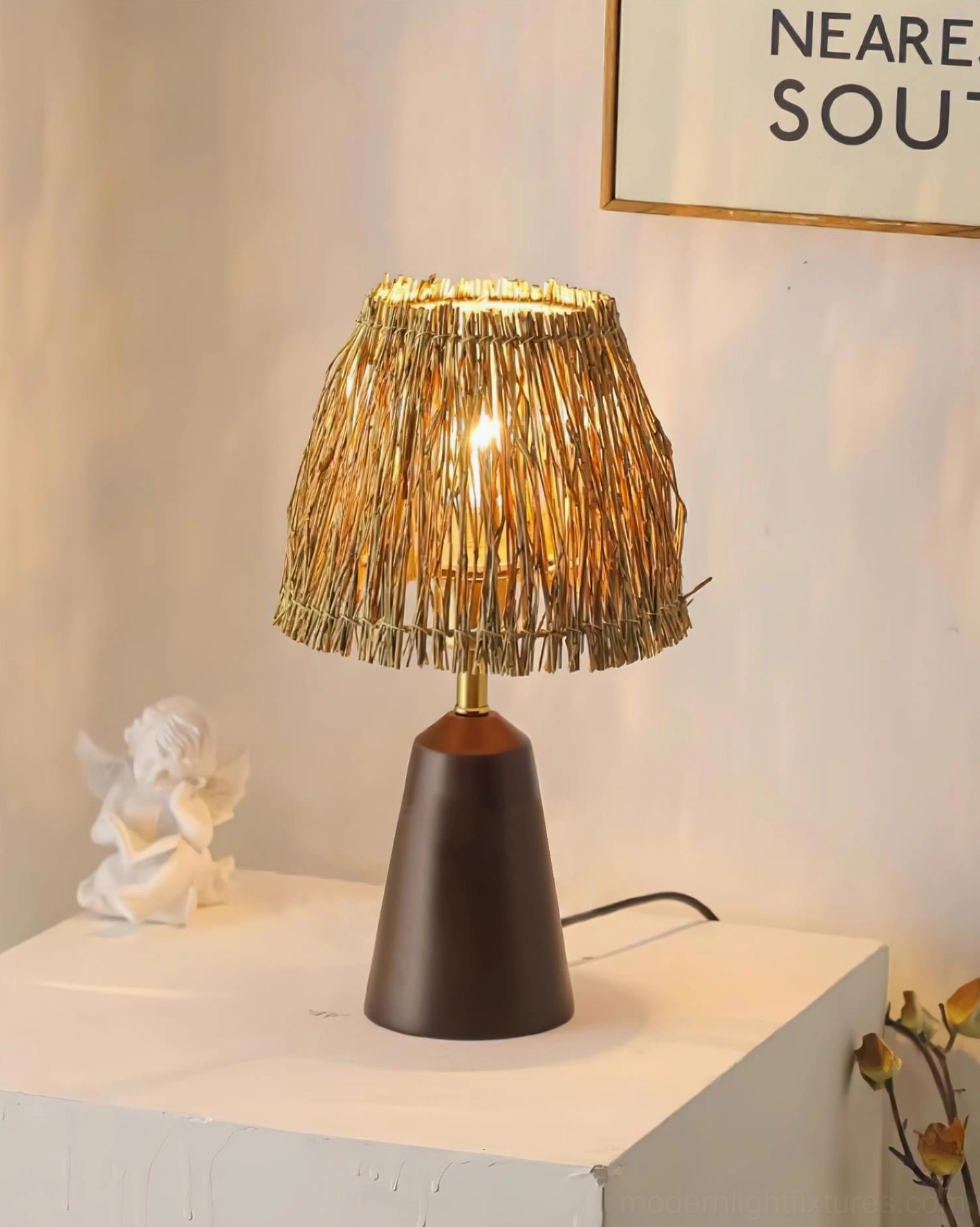 Dark brown rustic bohemian table lamp with handwoven straw shade on modern side table
