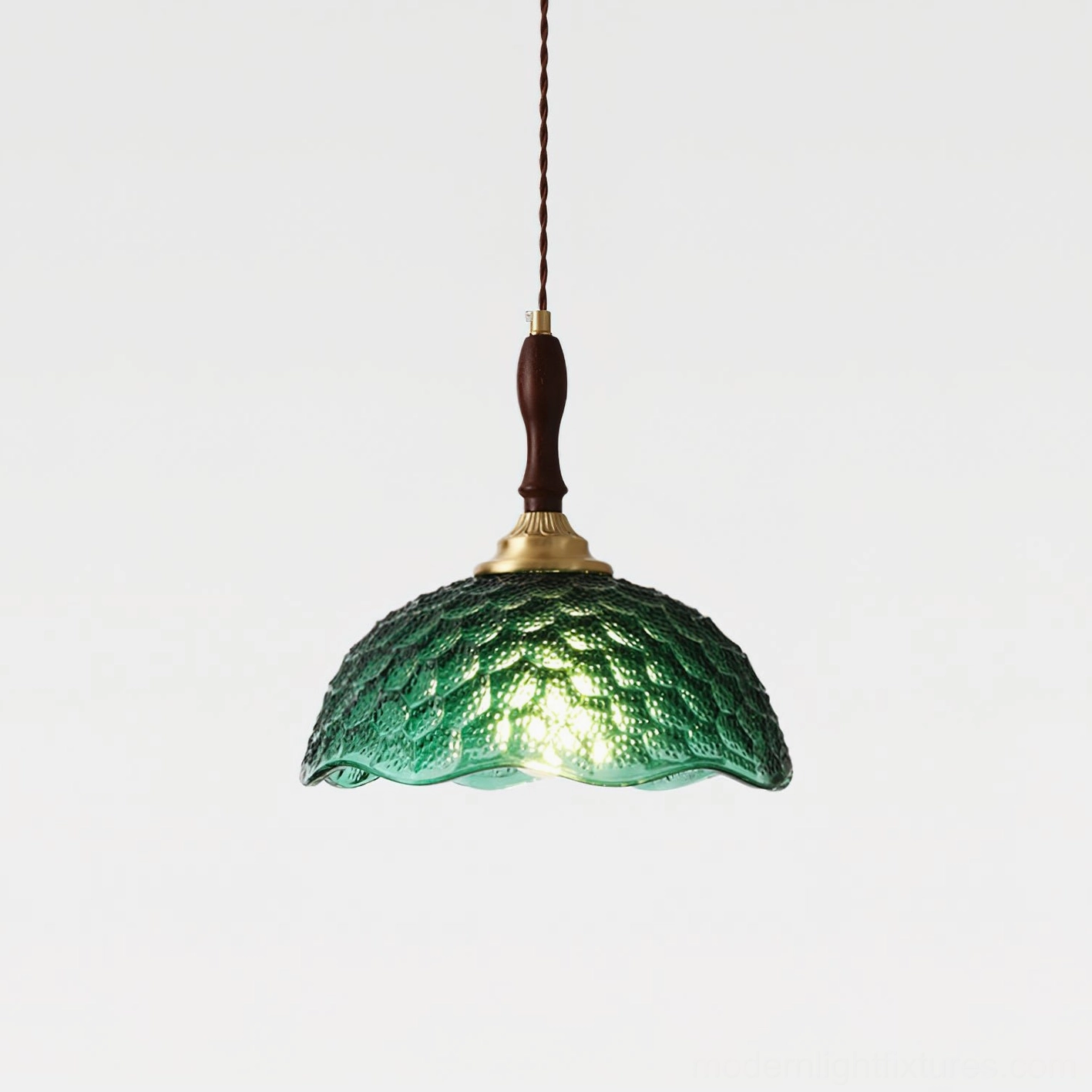 Dark green embossed glass scalloped pendant lamp three-quarter front view with brass vintage hardware