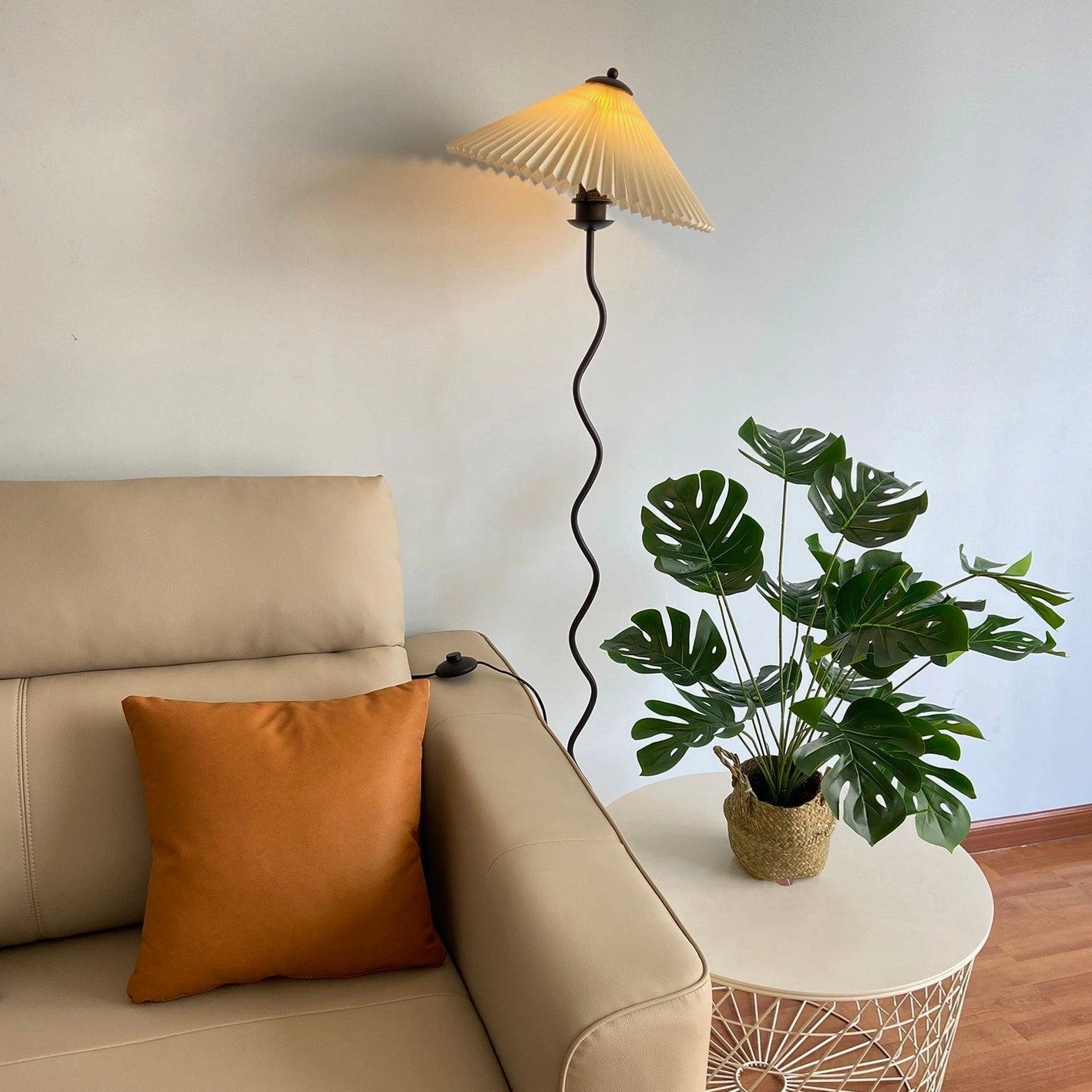 Dark green squiggle floor lamp with fabric shade in eclectic interior - bold artistic lighting statement