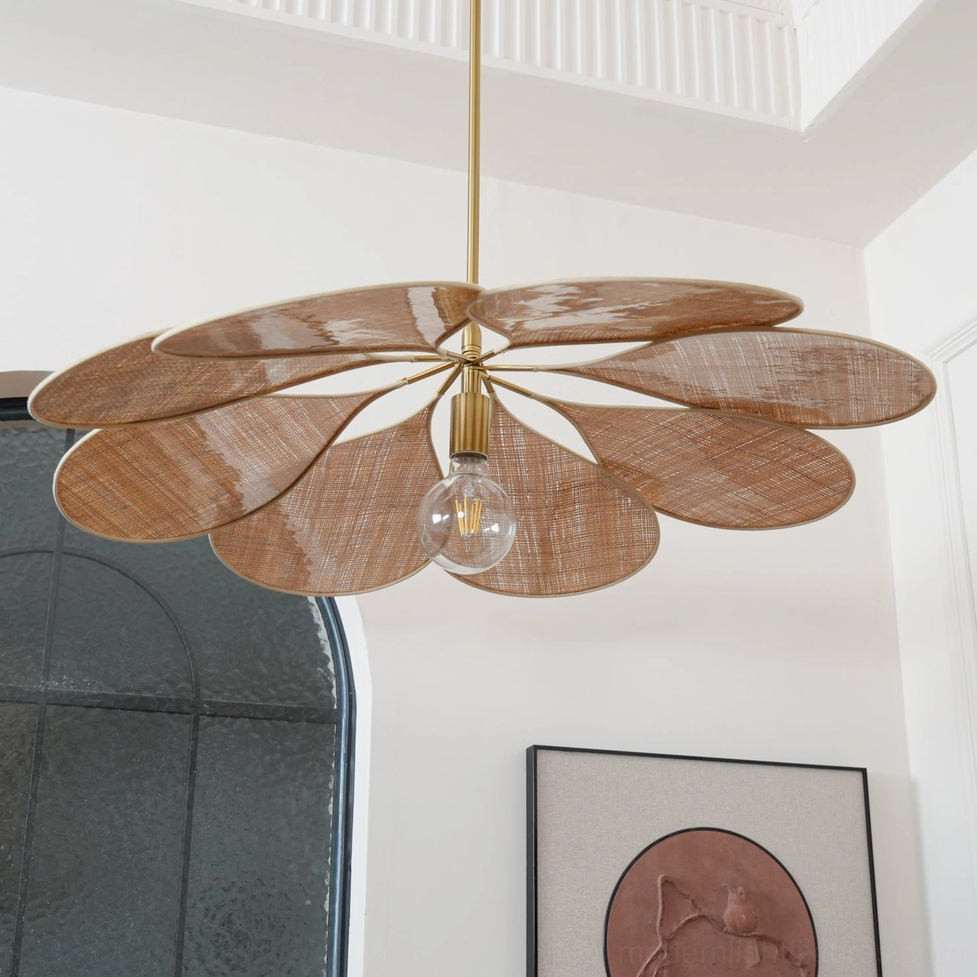 Dark-toned natural rattan pendant lamp creating layered shadow play in residential interior