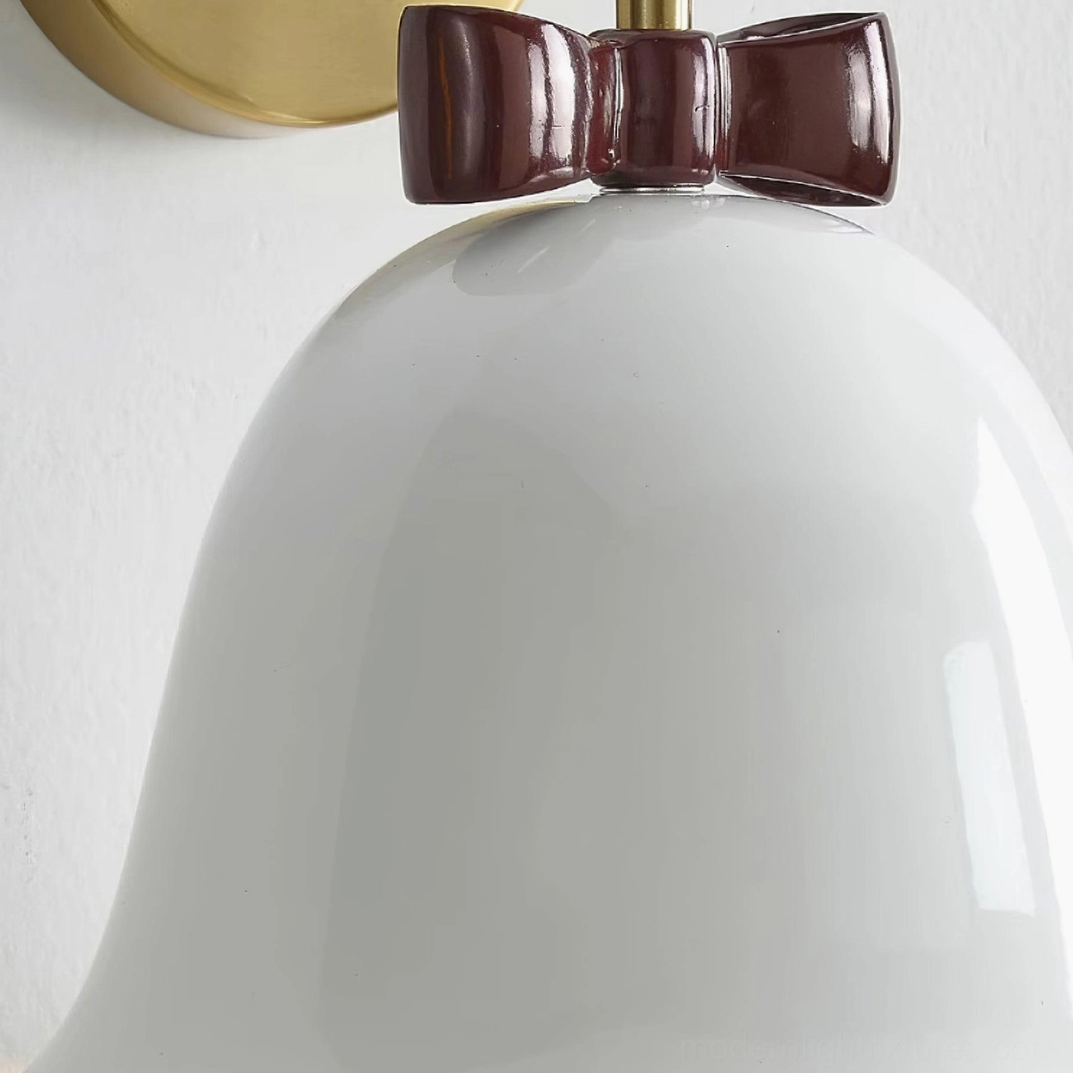 Decorative bell-shaped wall sconce combining whimsical bow detail with minimalist modern design