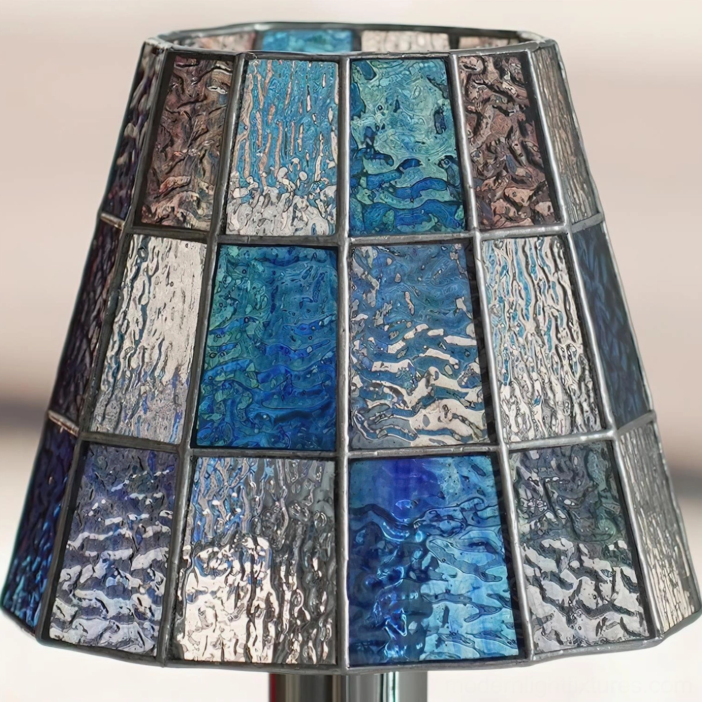 Decorative stained glass table lamp with intricate geometric pattern creating ambient and task lighting effects