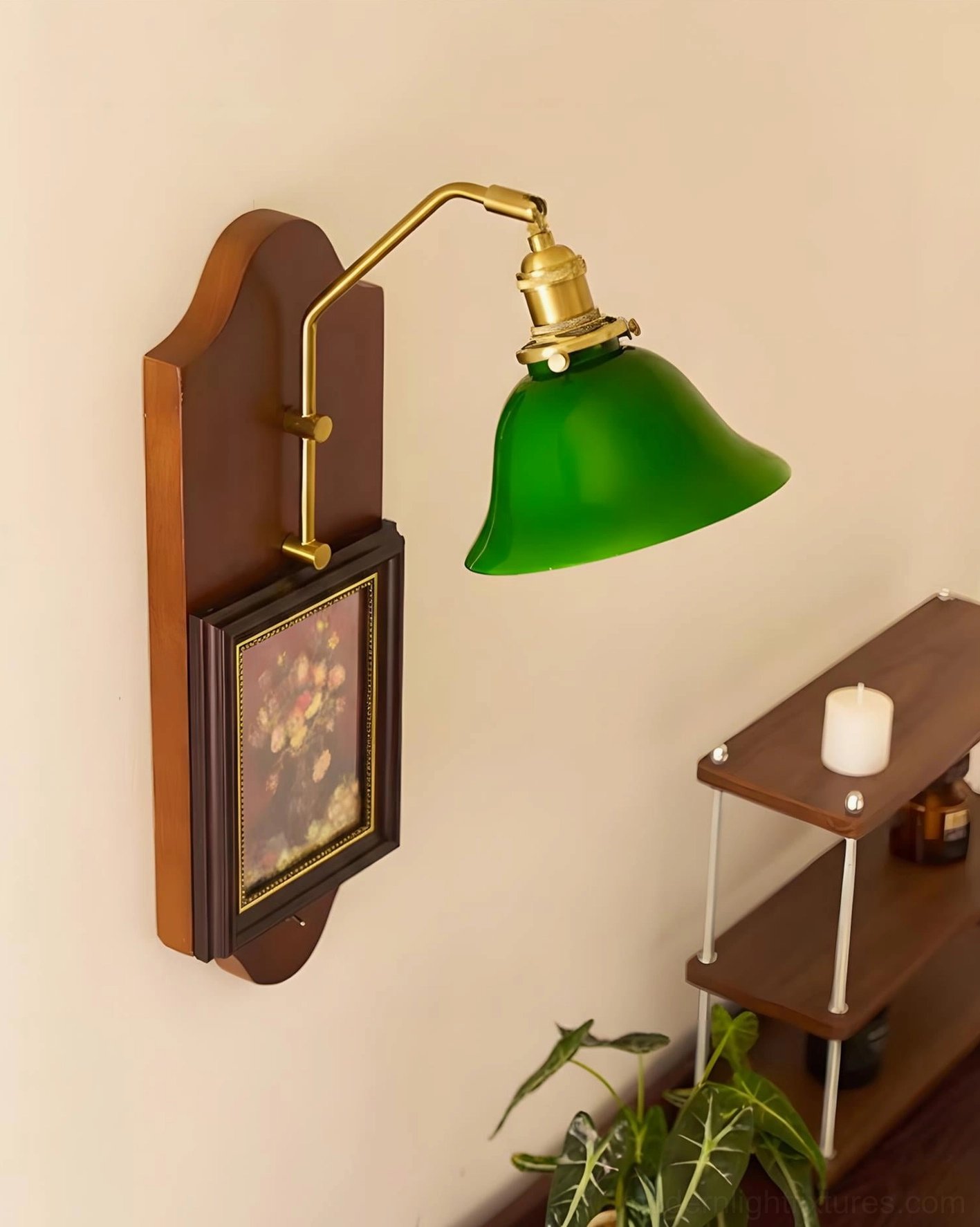 Front-right angle of decorative wall sconce with green glass shade and brass hardware on accent wall