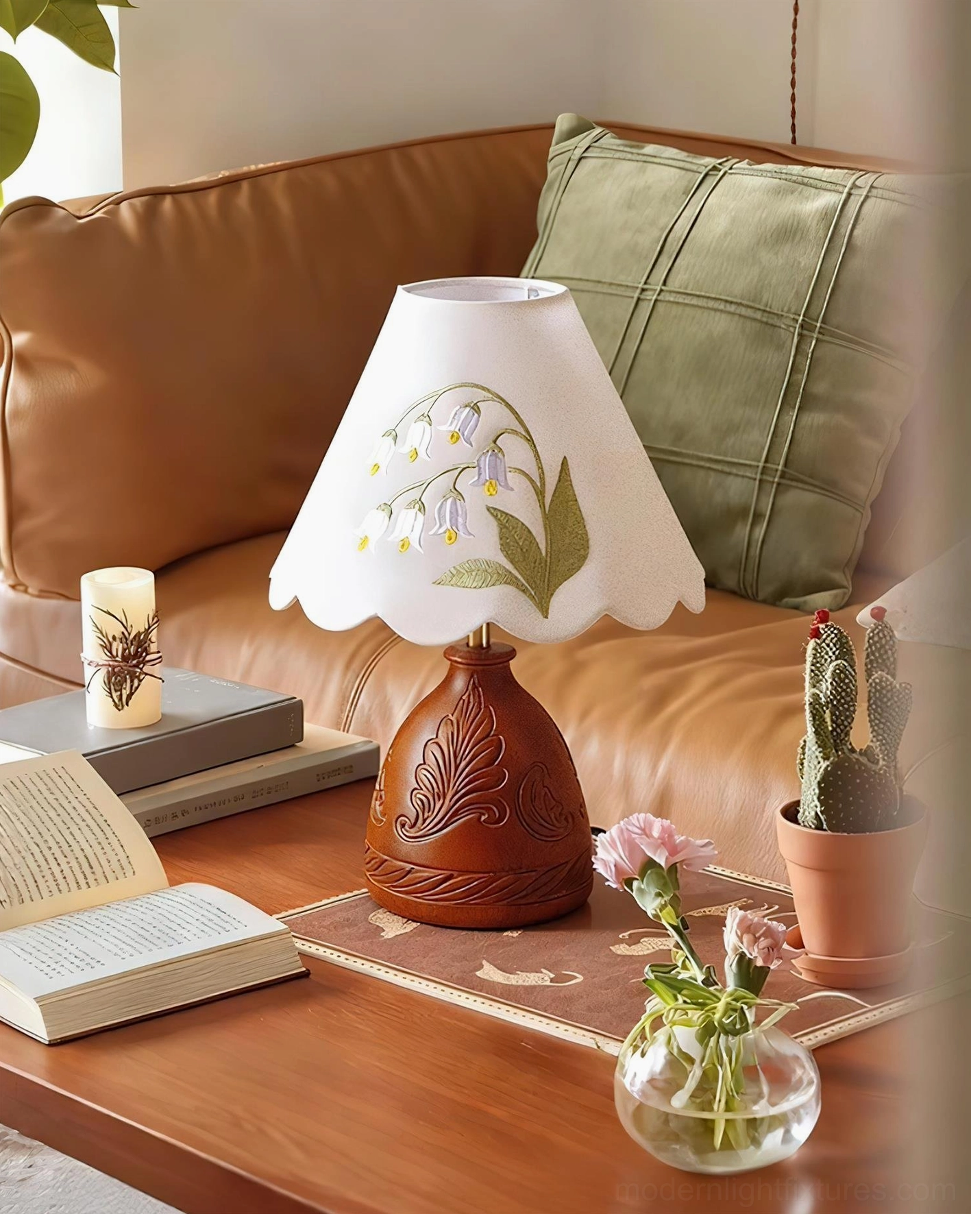 Vintage table lamp styled in modern living room setting with leather sofa and botanical décor