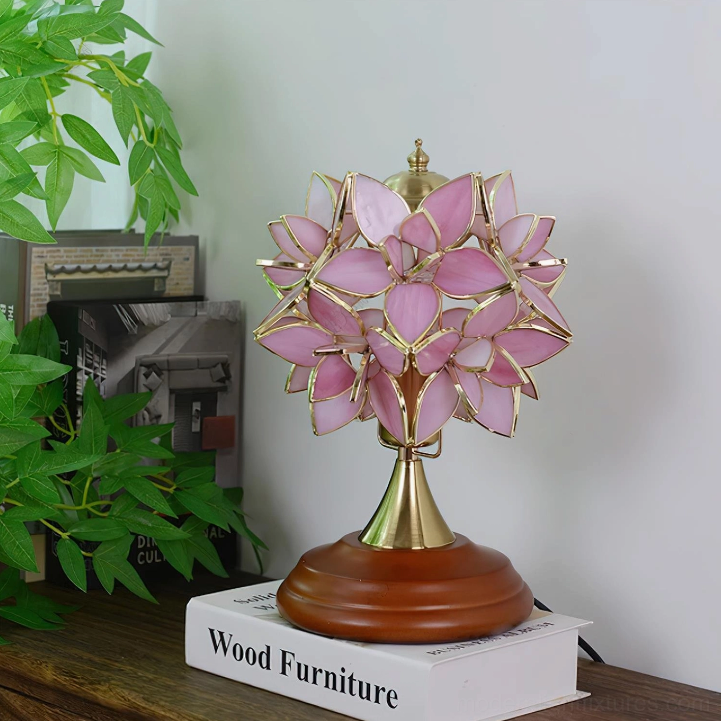 Deep pink petal Tiffany stained glass table lamp creating warm atmospheric lighting on home furniture