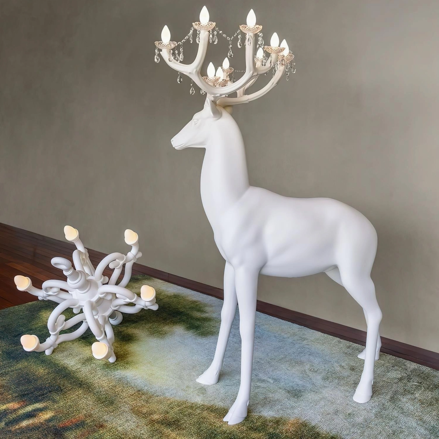 White deer floor lamp next to separate tabletop chandelier decor in modern showroom setting