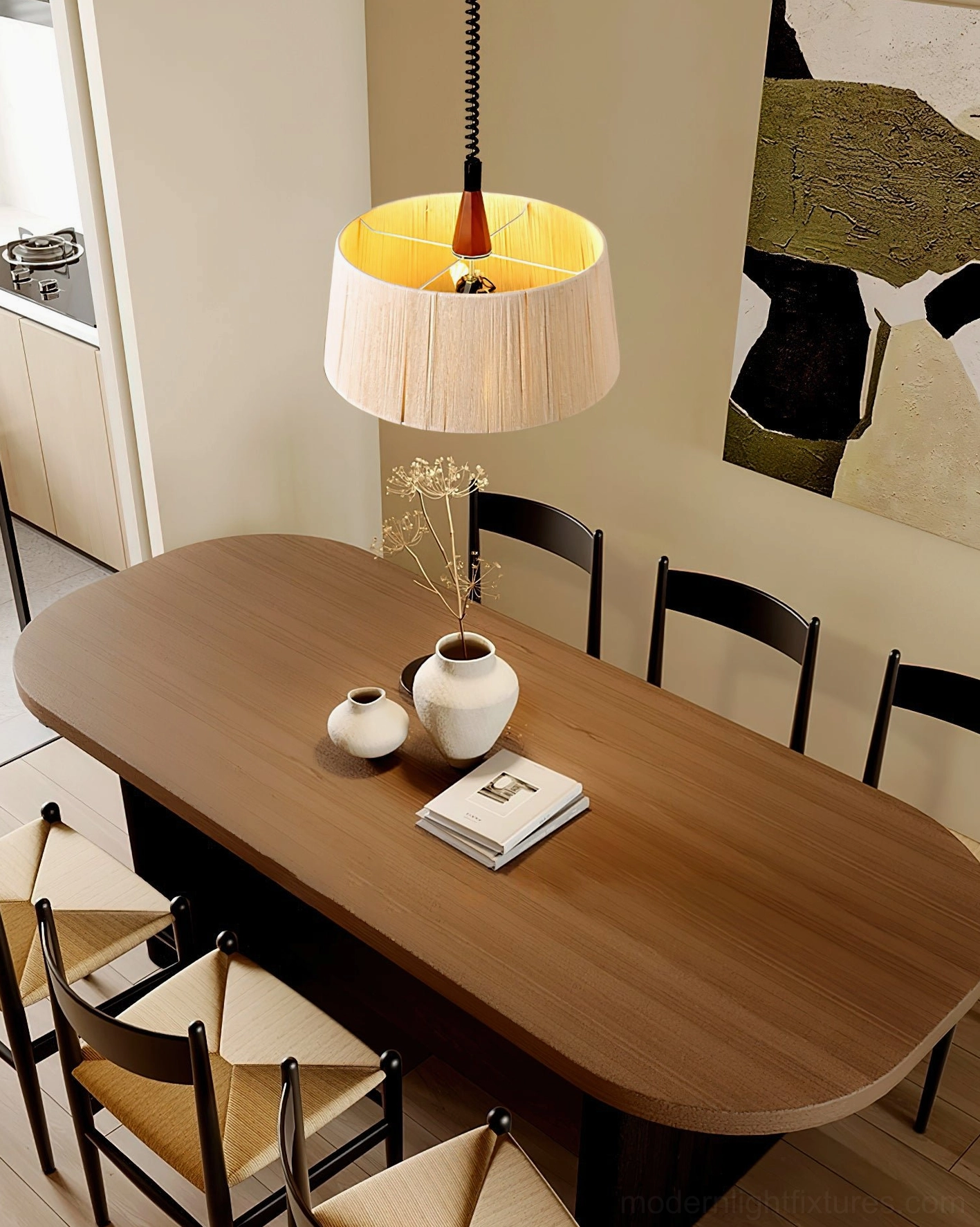 Delaney pendant light installed above wooden dining table with black chairs - rustic modern dining room ambiance lighting