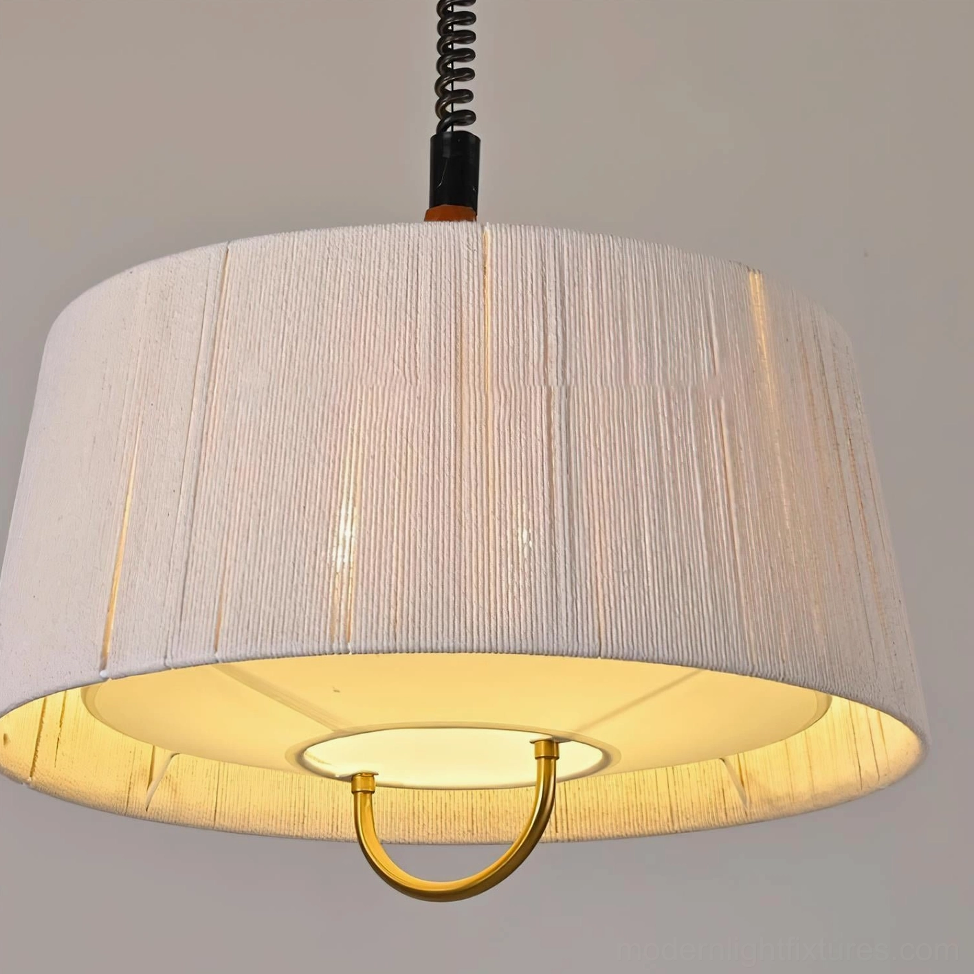 Delaney tapered drum pendant extreme close-up showing fine pleated hemp rope texture and polished gold metal lower ring detail