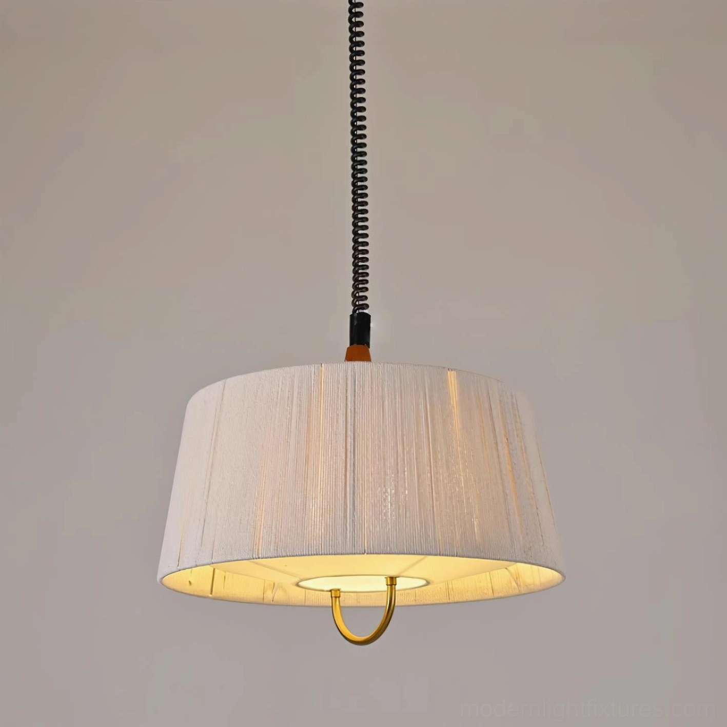 Delaney pendant light close-up frontal view showing pleated beige fabric shade texture with warm glowing inner light