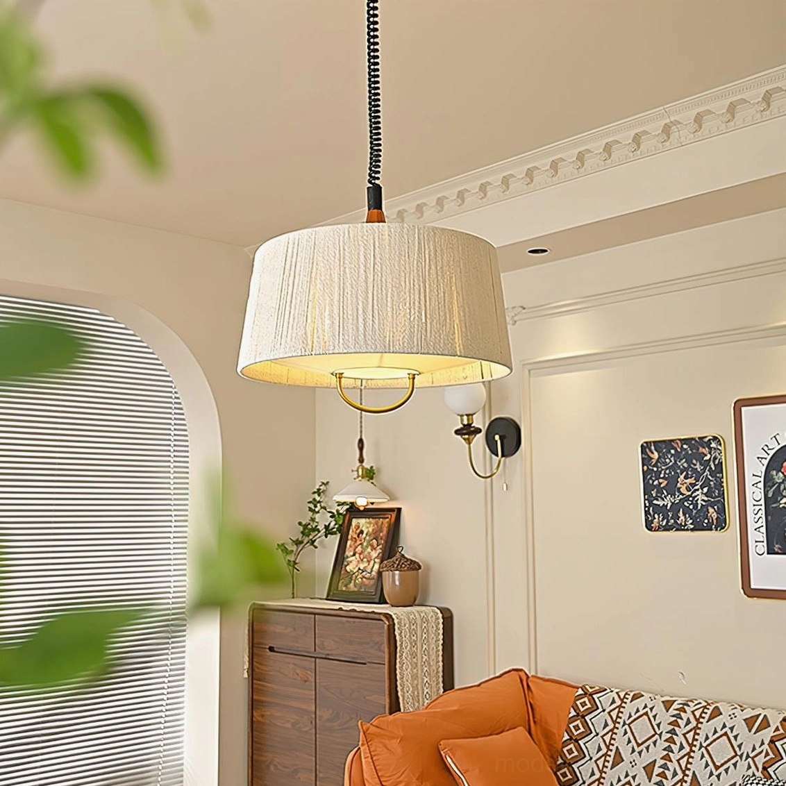 Delaney pendant light installed in warm vintage living room with orange sofa, creating soft ambient lighting with natural hemp texture