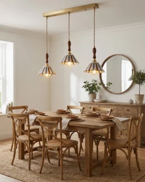 Three-head linear pendant light set with striped conical shades and brass mounting rod in formal dining room