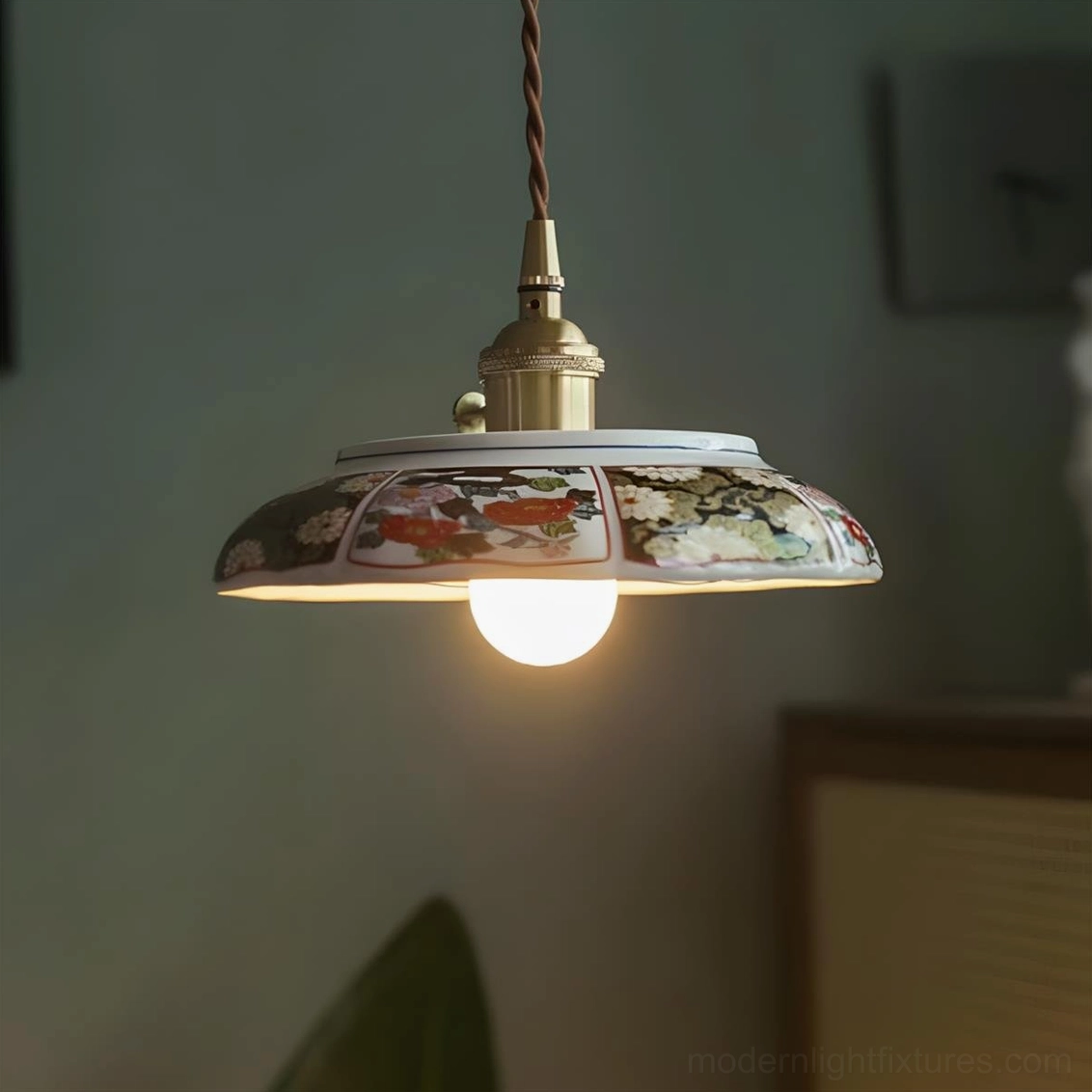 Delphora hand-painted ceramic pendant light featuring shallow saucer shade with decorative bordered rim pattern