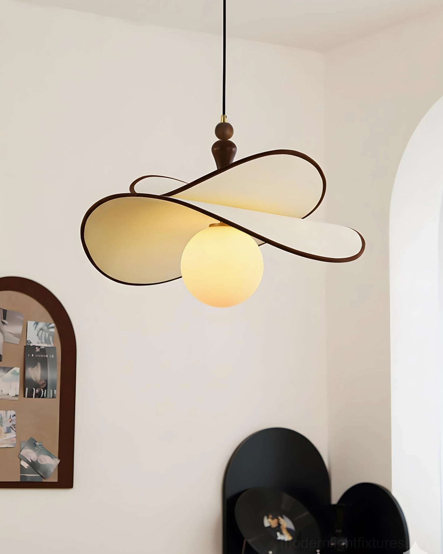 Designer petal pendant light with organic sculptural form showing overlapping fabric petals and warm illuminated glass spheres, artistic modern fixture