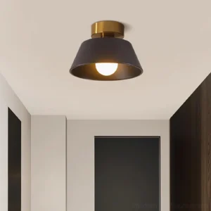 Devon tapered semi-flush ceiling light installed in modern hallway with warm exposed bulb glowing, eye-level perspective