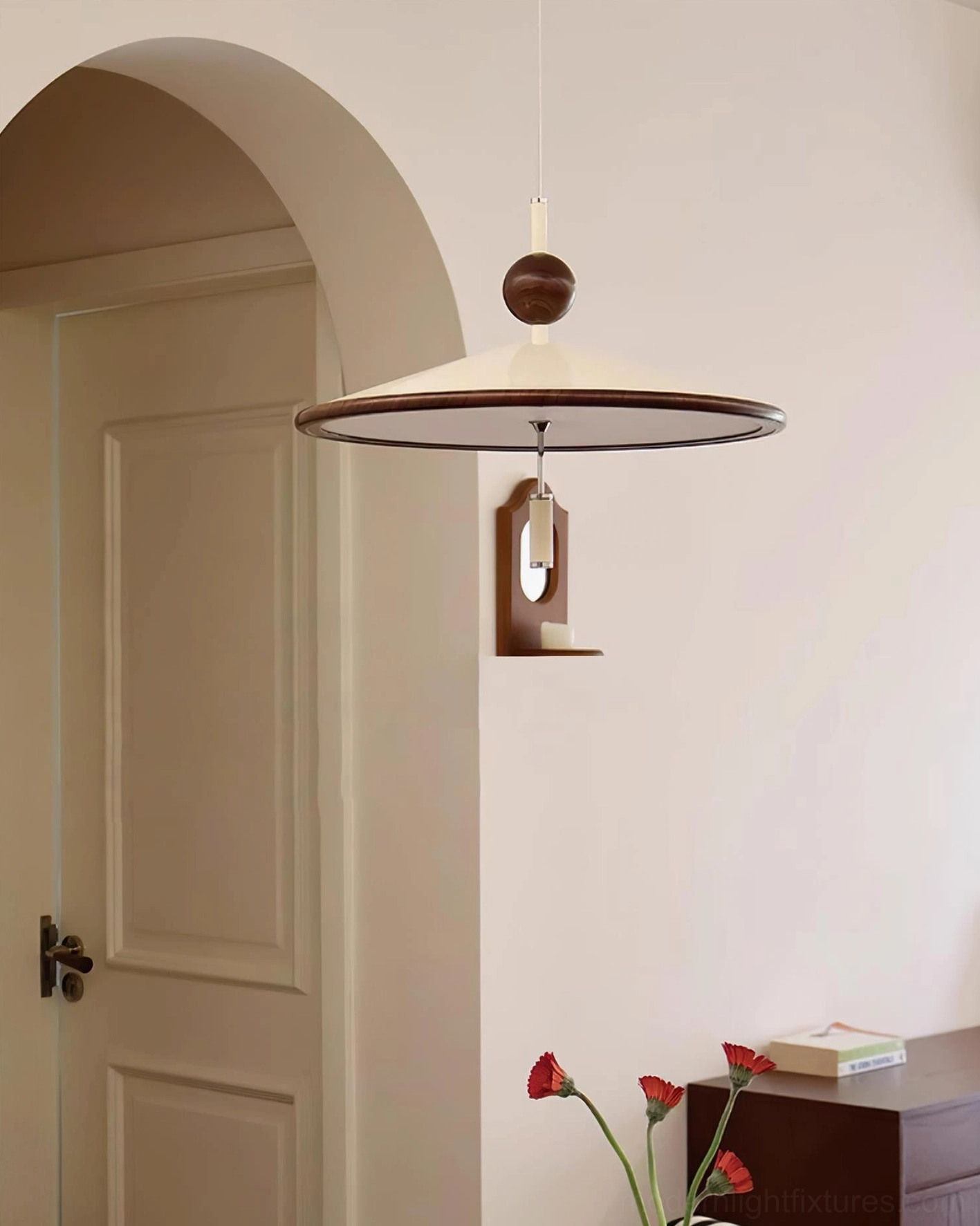 Devon pendant light hanging in residential entryway with arched doorway and warm neutral aesthetics