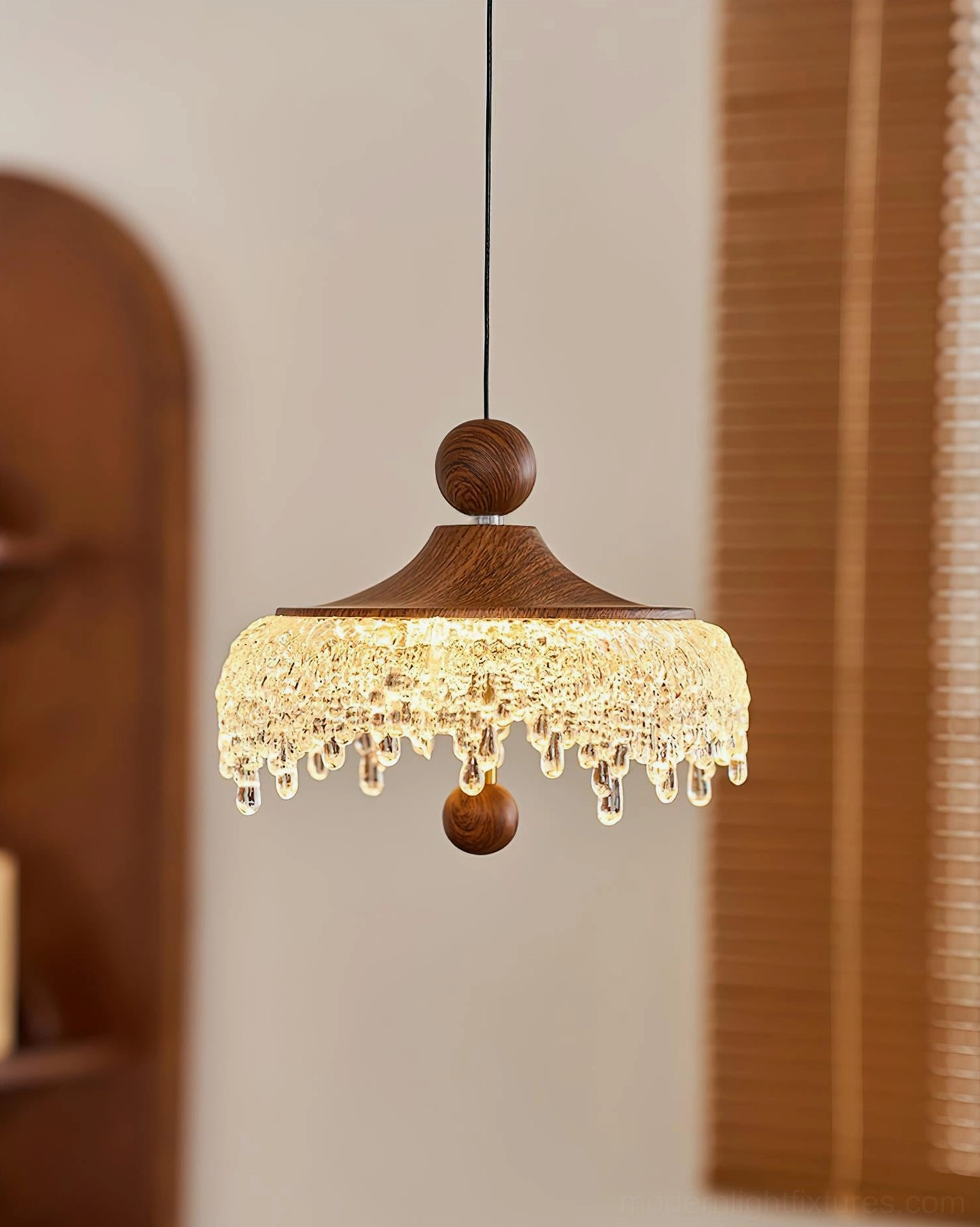 Dewdrop Halo glass droplet pendant light, three-quarter side angle showing walnut wood cap detail