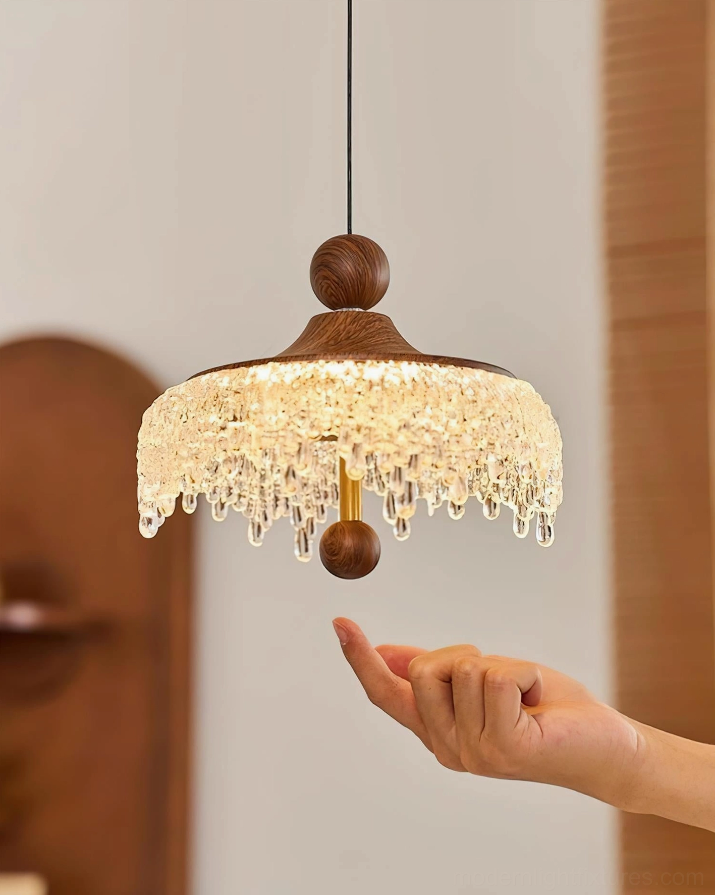 Dewdrop Halo contemporary pendant light with size reference hand for compact dimensions