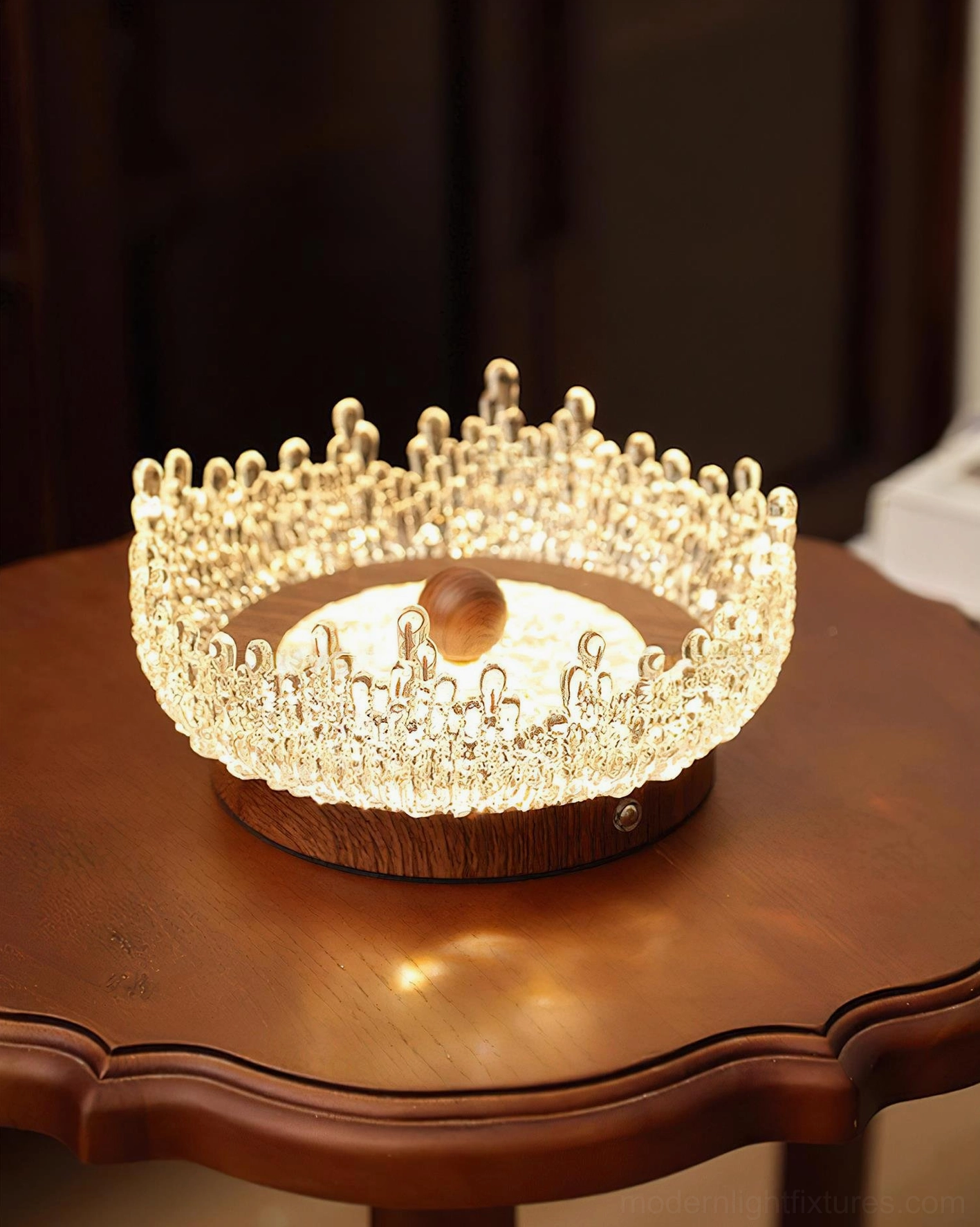 Modern Dewdrop Halo LED lamp three-quarter front view on dark walnut side table bright light