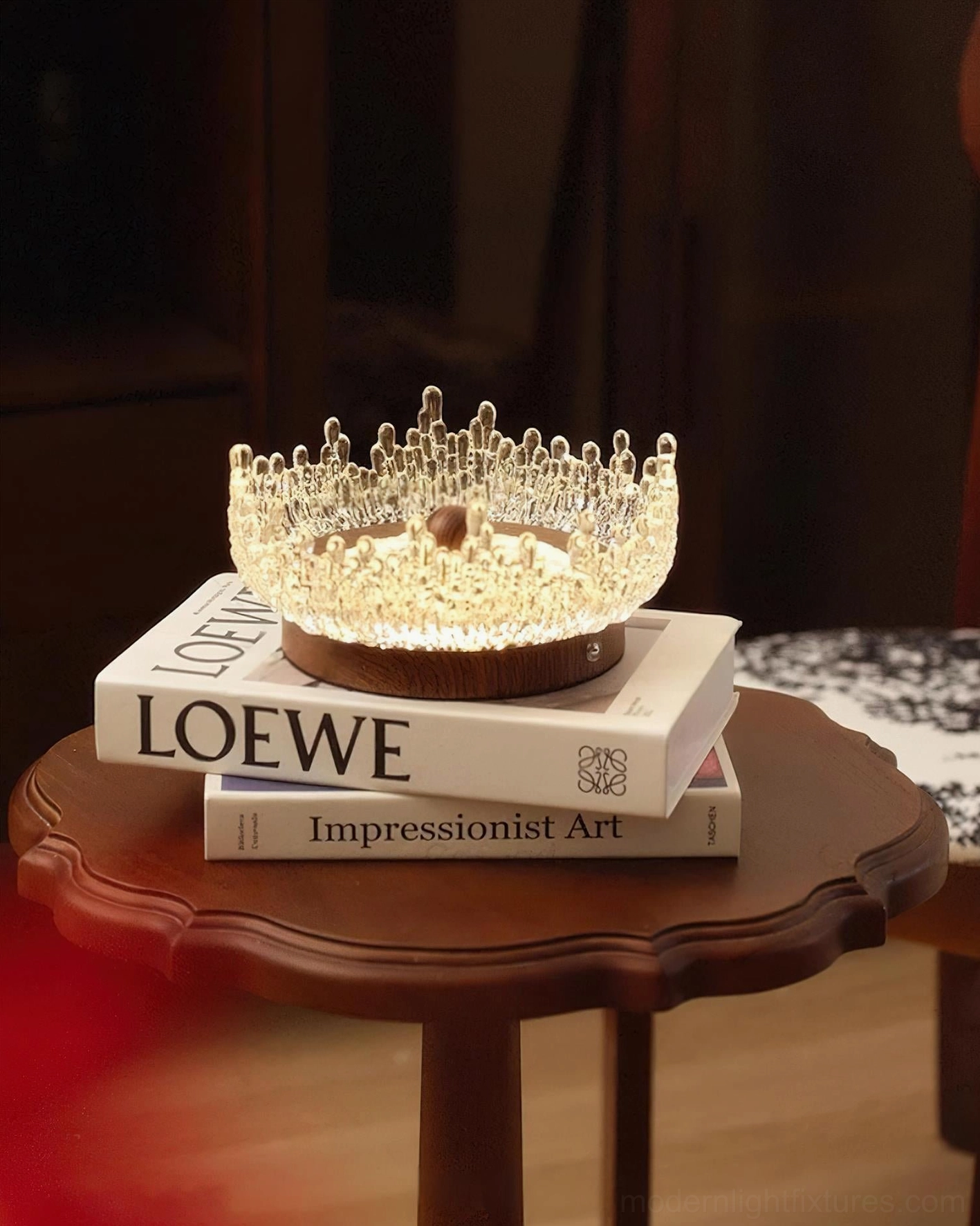 Dewdrop Halo contemporary table lamp low angle view on vintage round table with stacked books