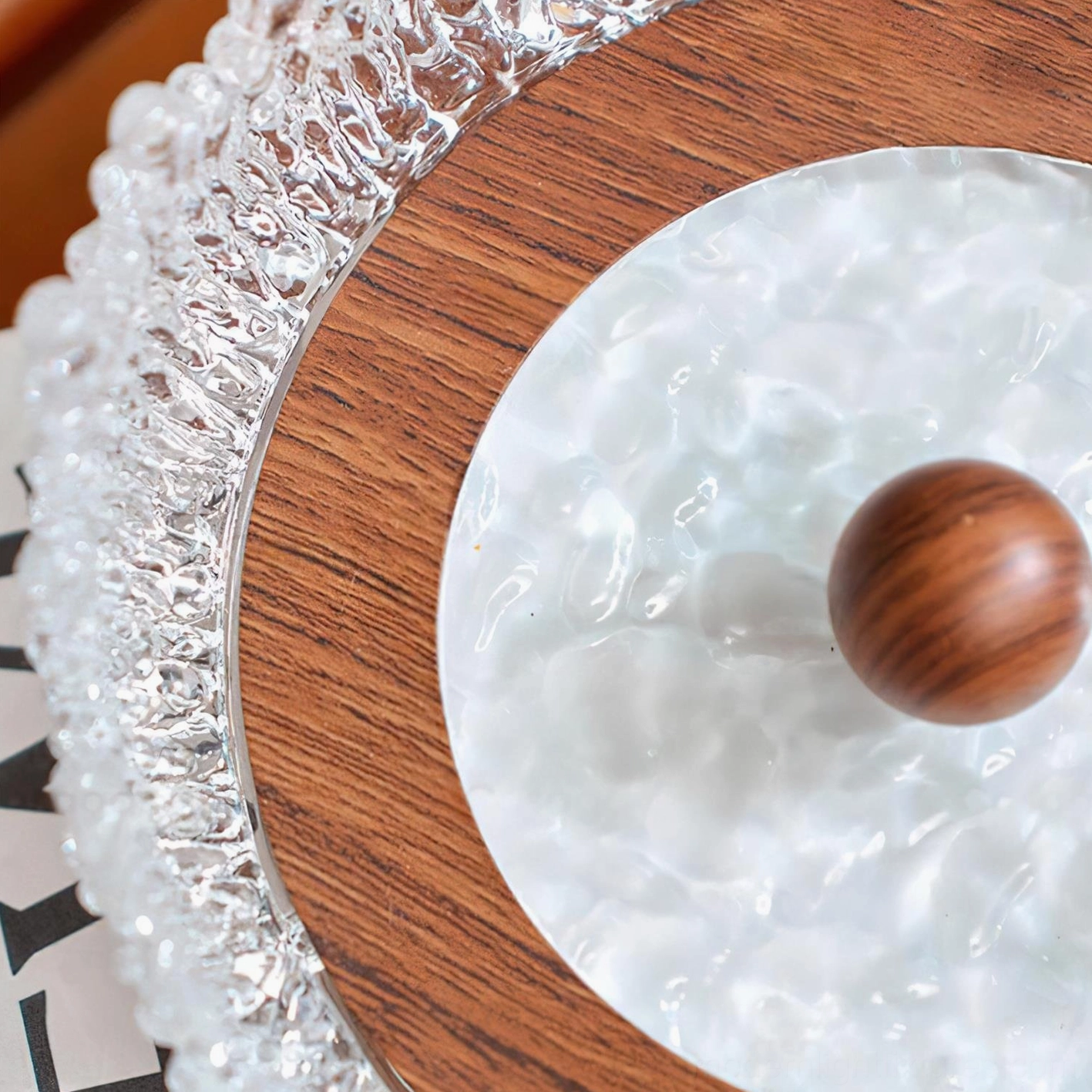 Top-down macro view Dewdrop Halo lamp rippled jade-like panel wood ring crystal border