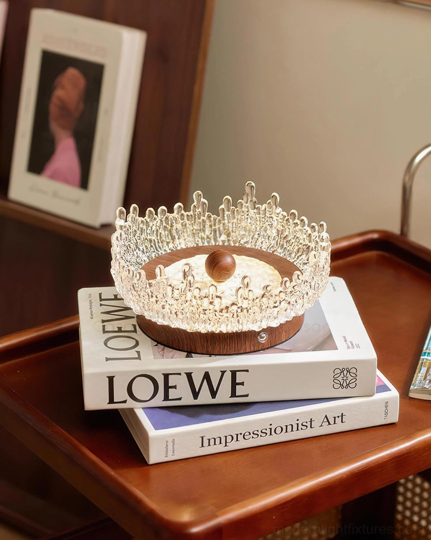 Dewdrop Halo modern crystal table lamp three-quarter view next to stacked art books home décor