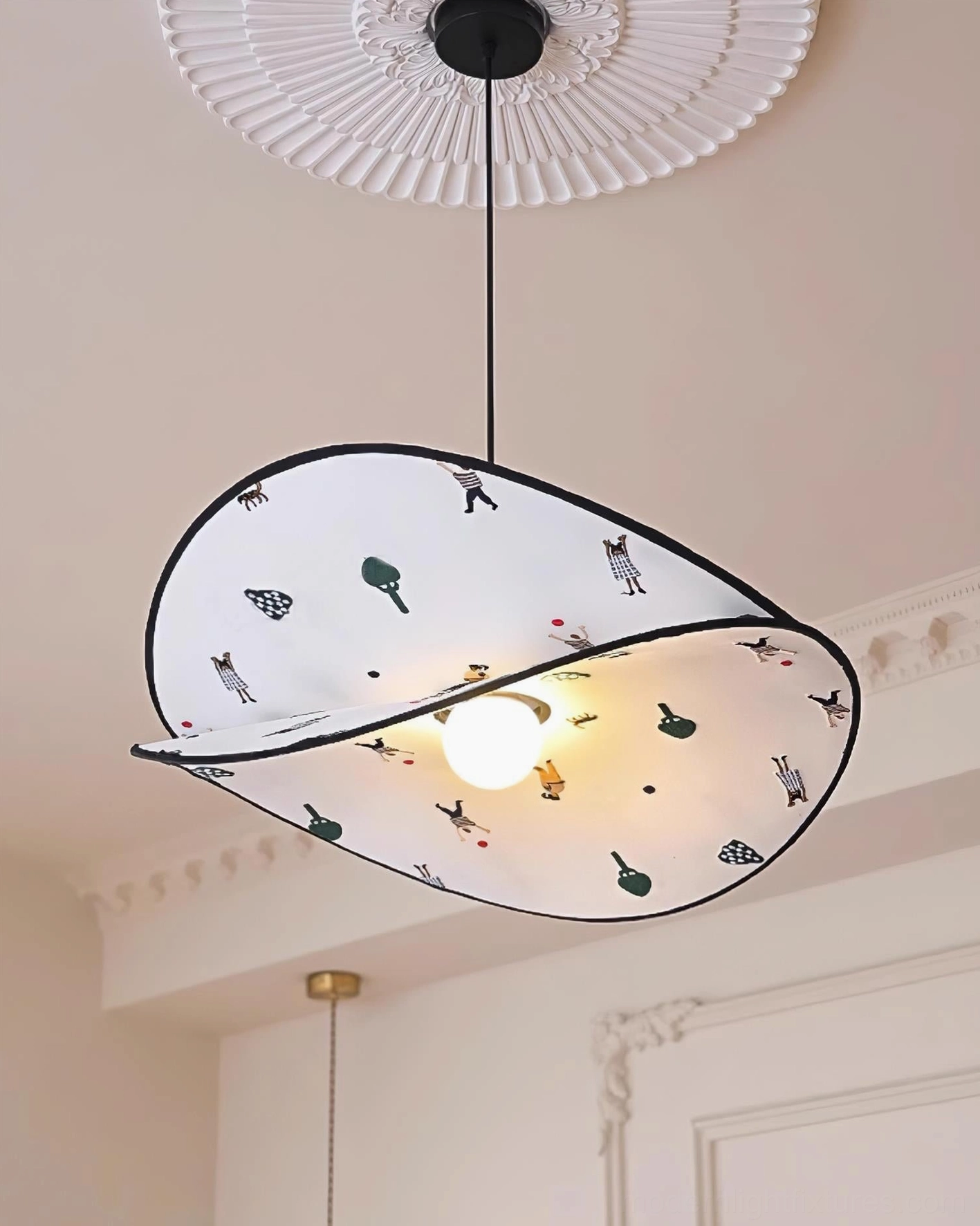 Close-up detail of Dika fabric pendant lamp showing playful nature-inspired print pattern and construction quality