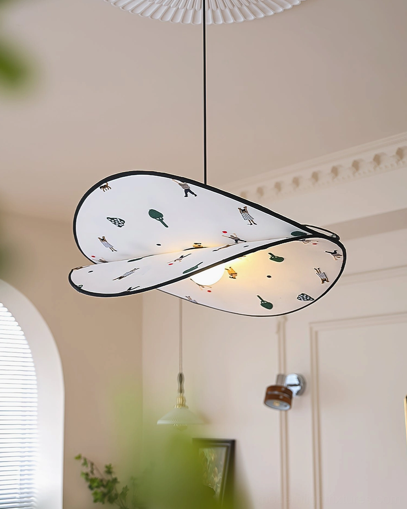 Dika fabric pendant light in three-quarter view, modern living room with arched window and cozy decor